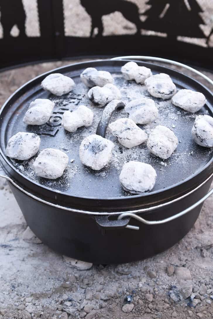 Hot briquettes on top of Dutch oven lid.