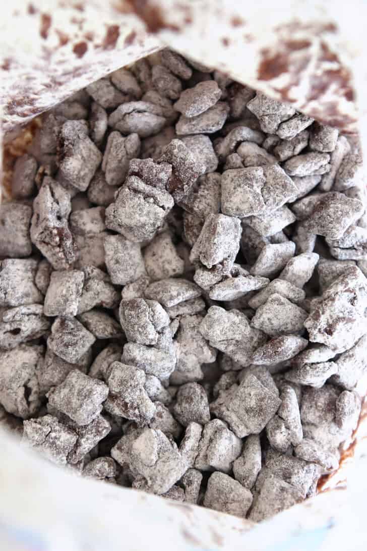 Fully dusted peanut butter and chocolate coated chex cereal with powdered sugar.