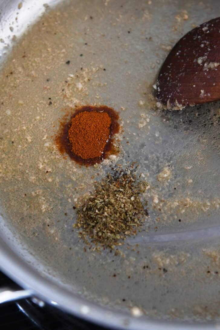 Stainless skillet with butter, garlic and spices.