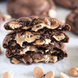 Four half cookies stacked on each other with melty peanut butter chips.