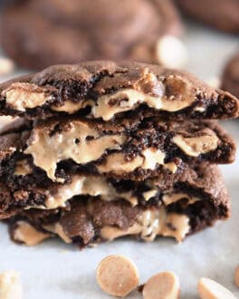 Four half cookies stacked on each other with melty peanut butter chips.