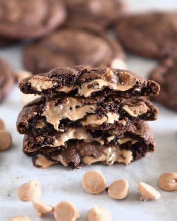 Four half chocolate cookies stacked on each other with melty peanut butter chips.