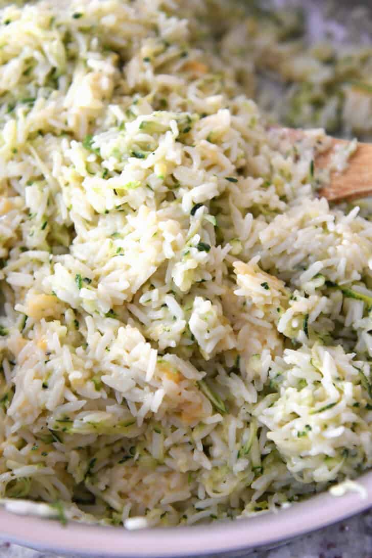 Top view of a pot filled with cheesy zucchini rice.