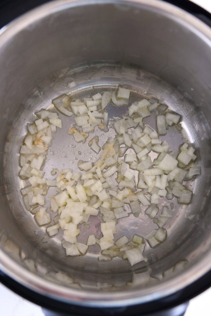 Top down view of Instant Pot with sauteed garlic and onions.