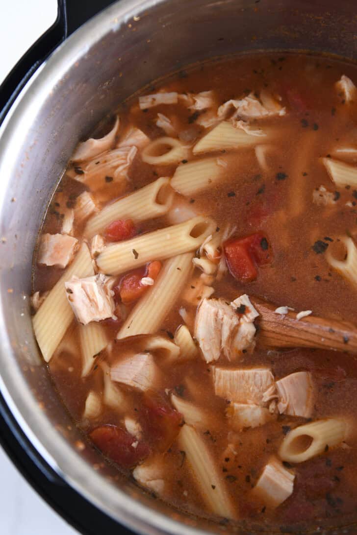 Cooked pasta, diced tomatoes, cooked chicken and seasonings in Instant Pot.