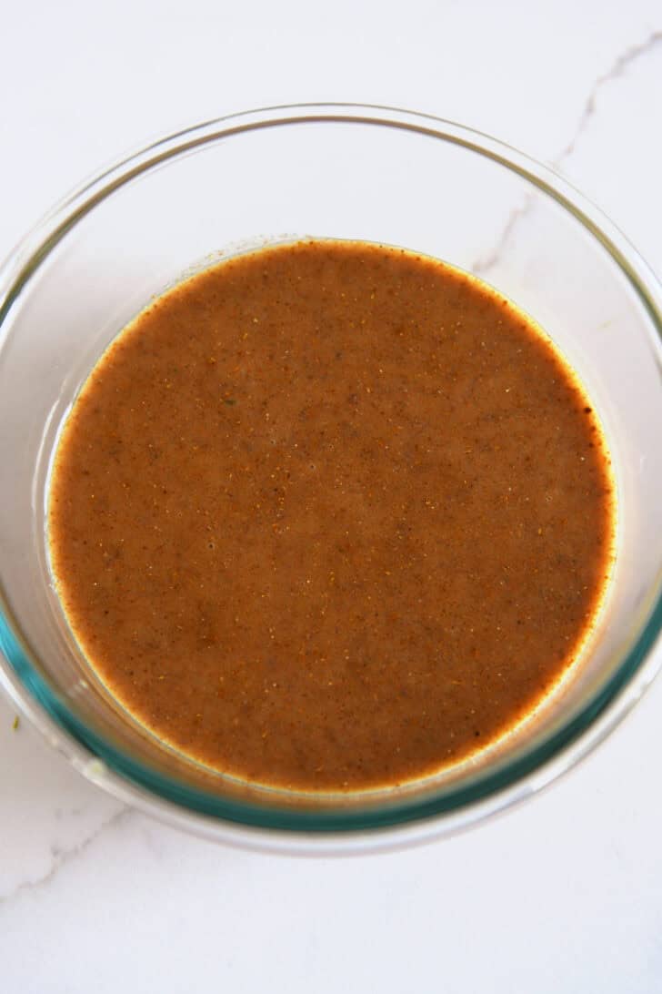 Glass bowl with curry coconut lime marinade.