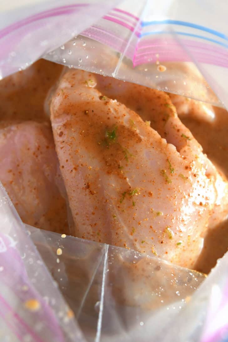 Chicken and marinade in ziplock bag.