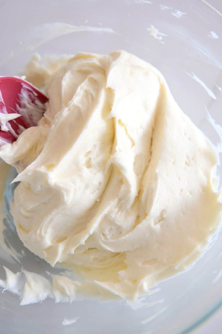 Whipped cream cheese and sugar in glass bowl.