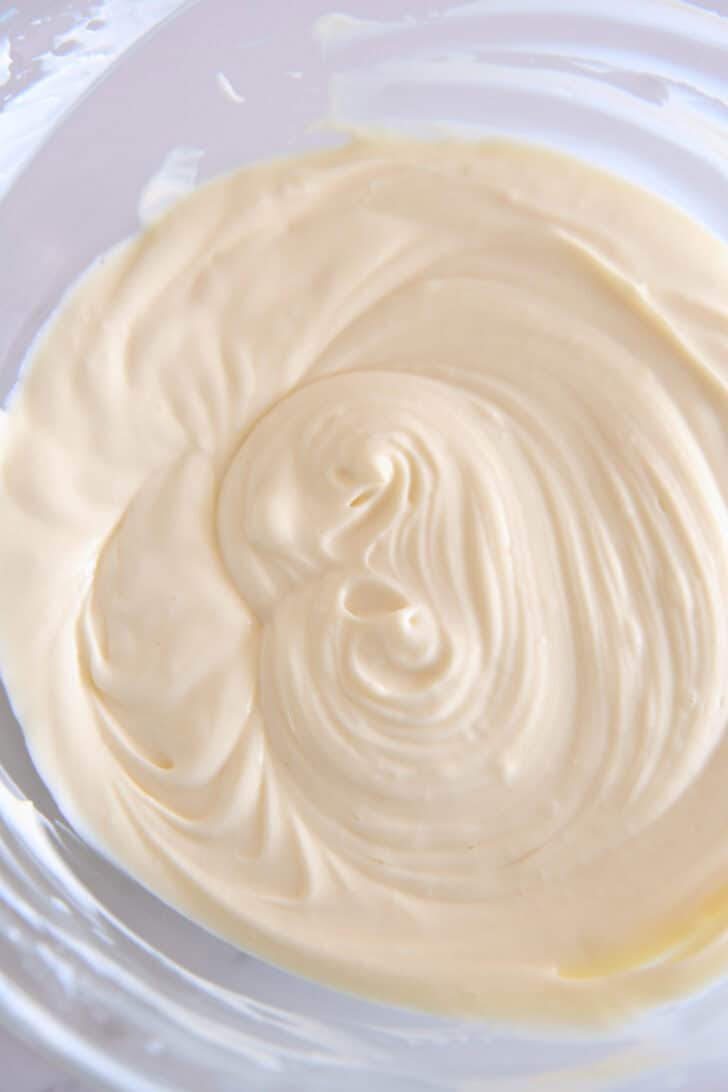 Glass bowl with cheesecake batter.