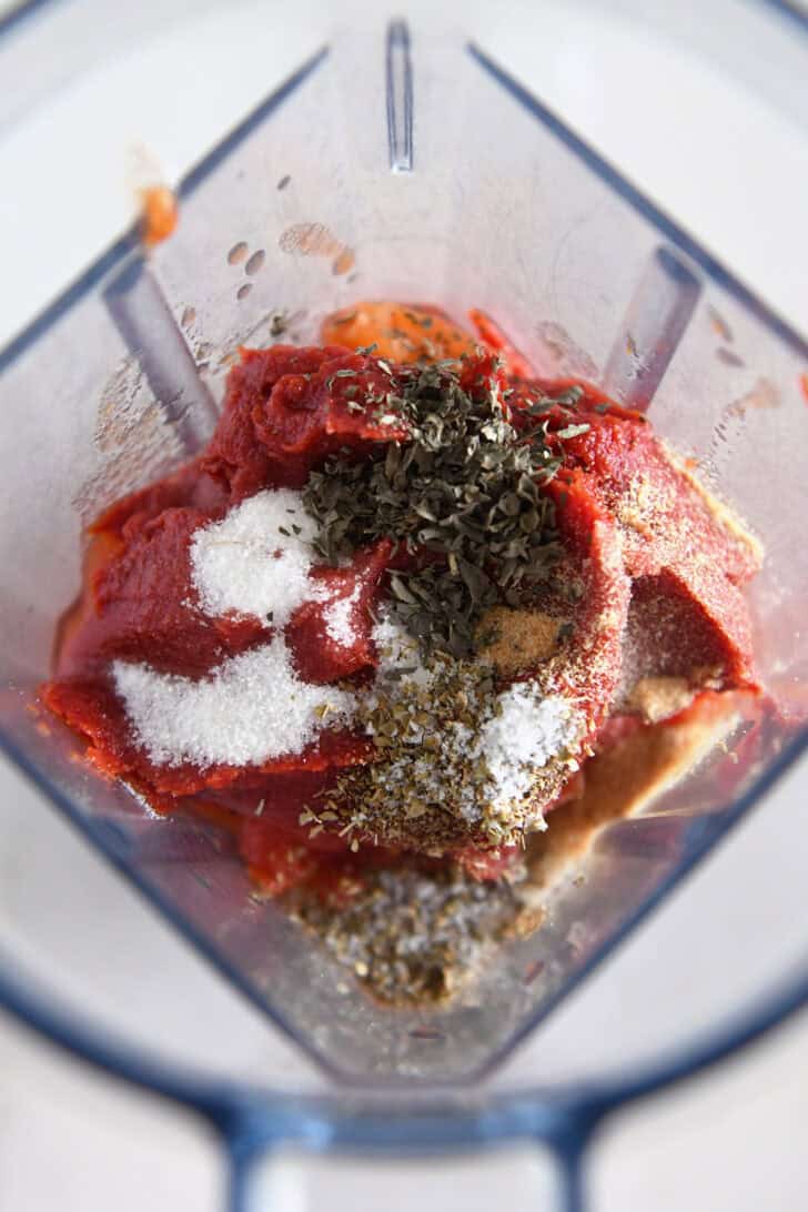 Blender with tomato paste, basil, oregano, salt and sugar.