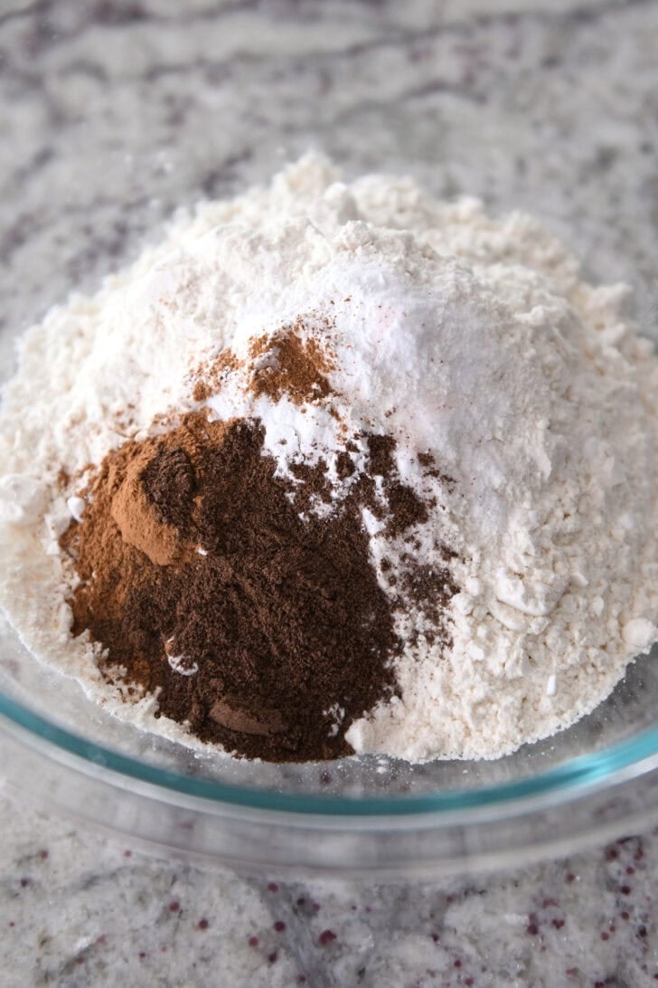 Glass bowl with flour, cinnamon nutmeg, cloves and salt.