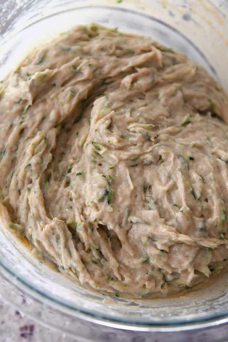 Glass bowl with mixed zucchini bread batter.