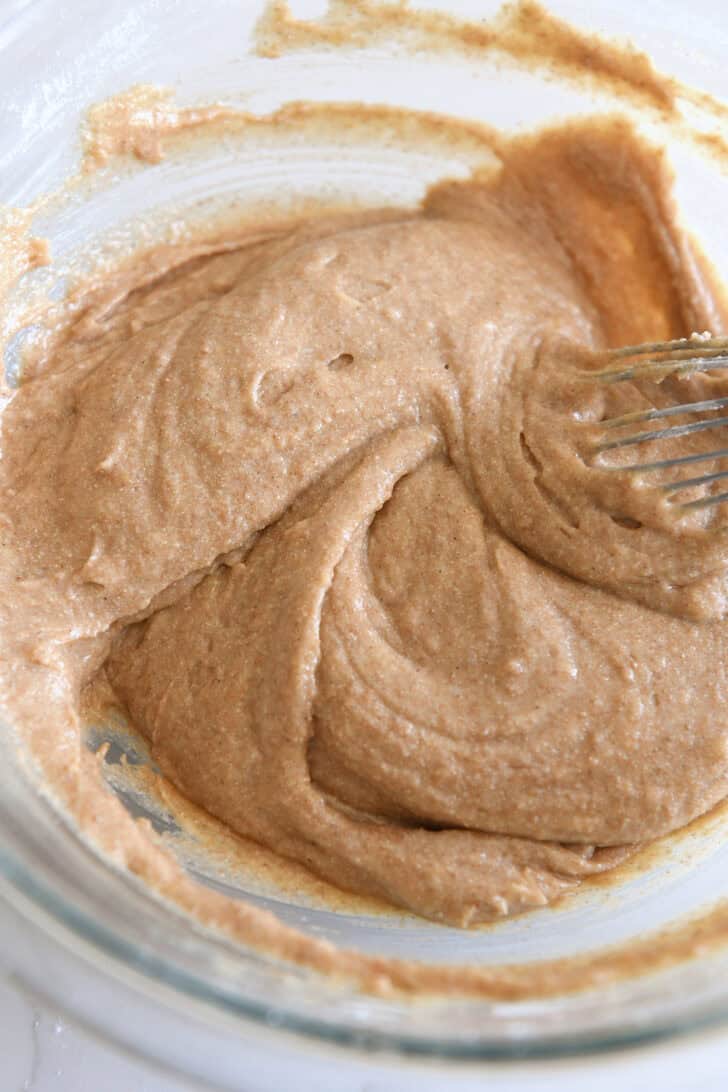 Apple cinnamon muffin batter in glass bowl.