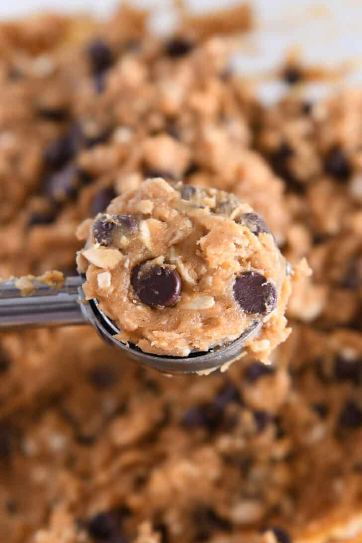 Medium cookie scoop filled with pumpkin chocolate chip oatmeal cookie batter.