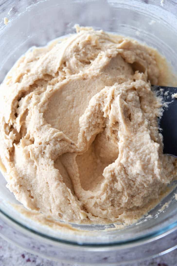 Top down view of cookie batter in a glass bowl.