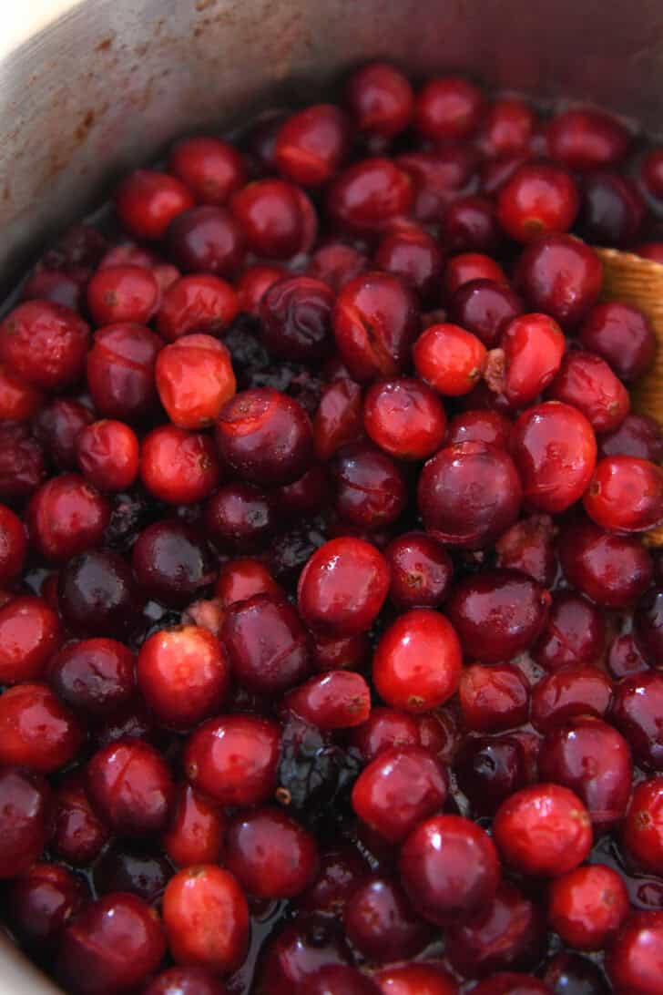 Saucepan with cooked cranberries that have split.