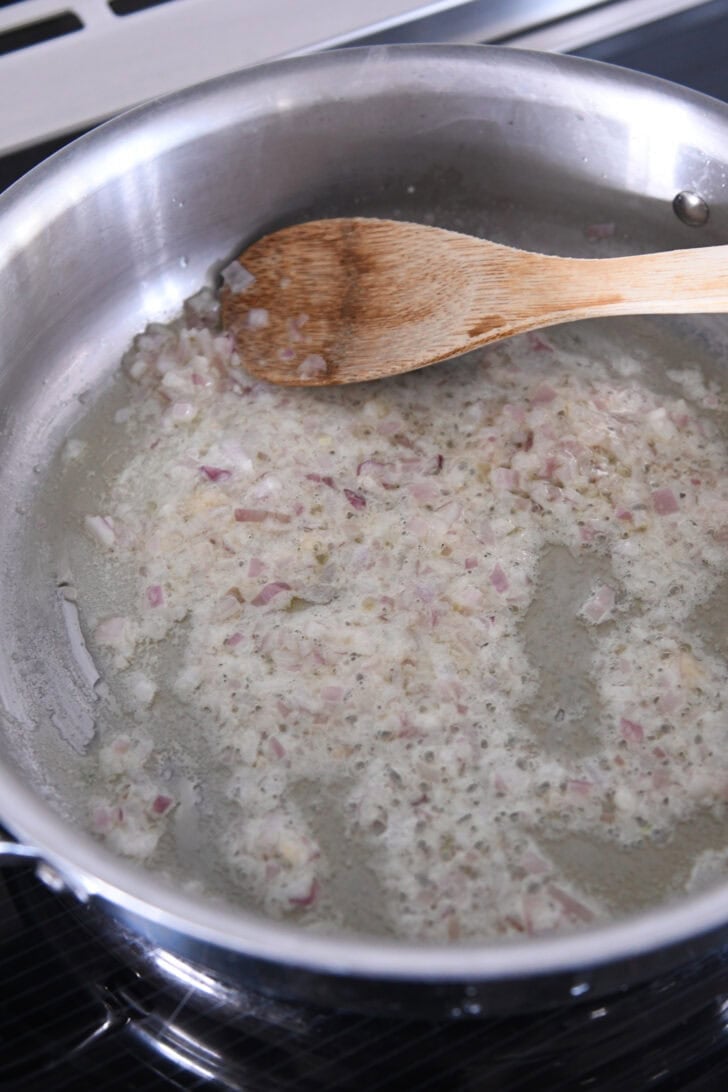 Sauteeing shallots and garlic in butter.