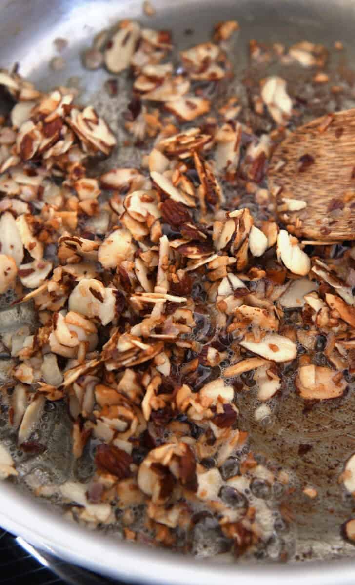 Buttery toasted almonds, garlic and shallots in skillet.