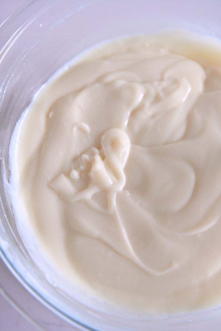 Glass bowl with thick, cooked white pudding.