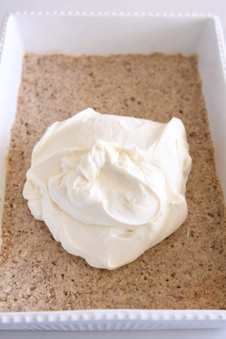 No-bake cheesecake batter piled on top of baked pecan shortbread crust.