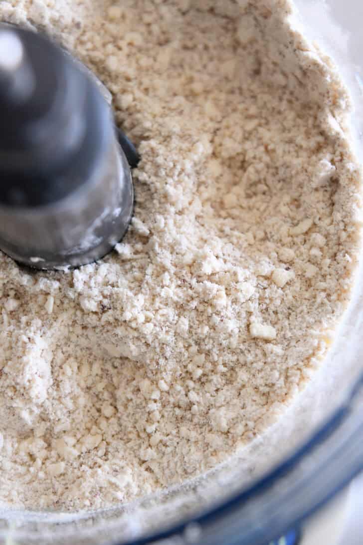 Finely chopped crumbs of pecans, flour and butter in food processor with blade.