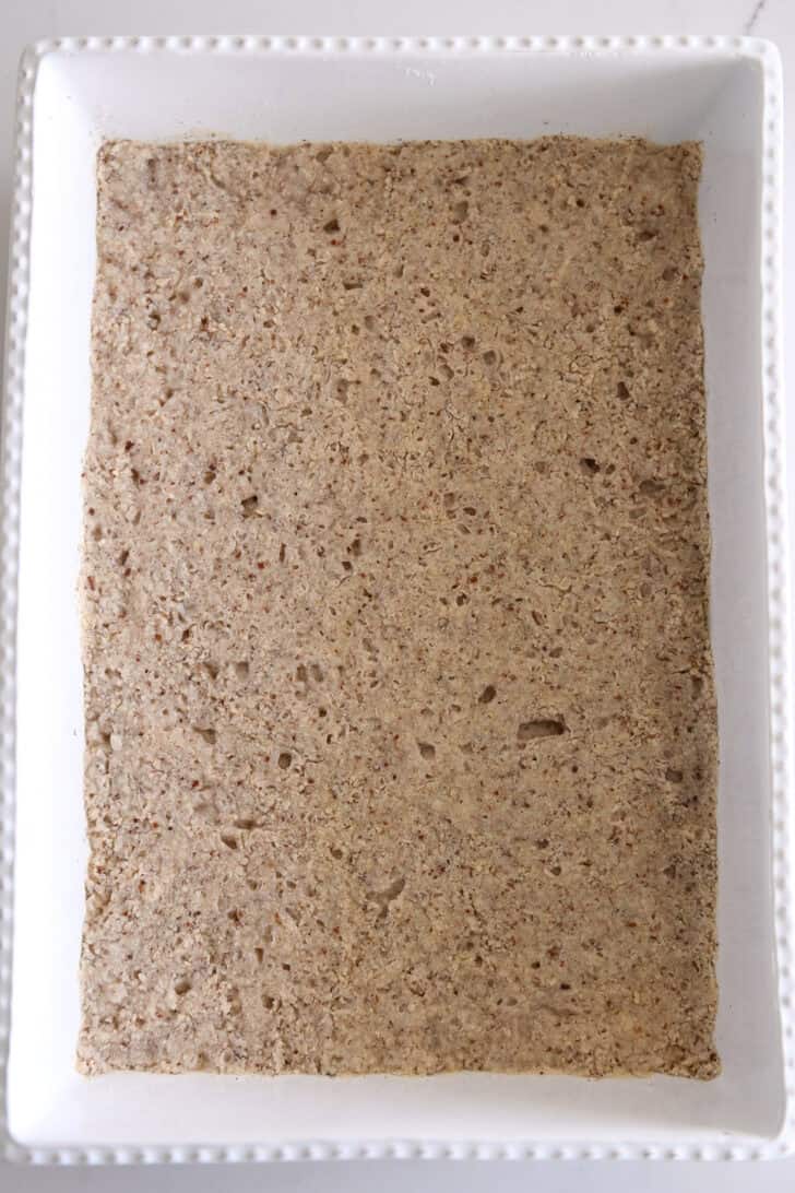 Pecan shortbread crust baked in white 9X13-inch pan.