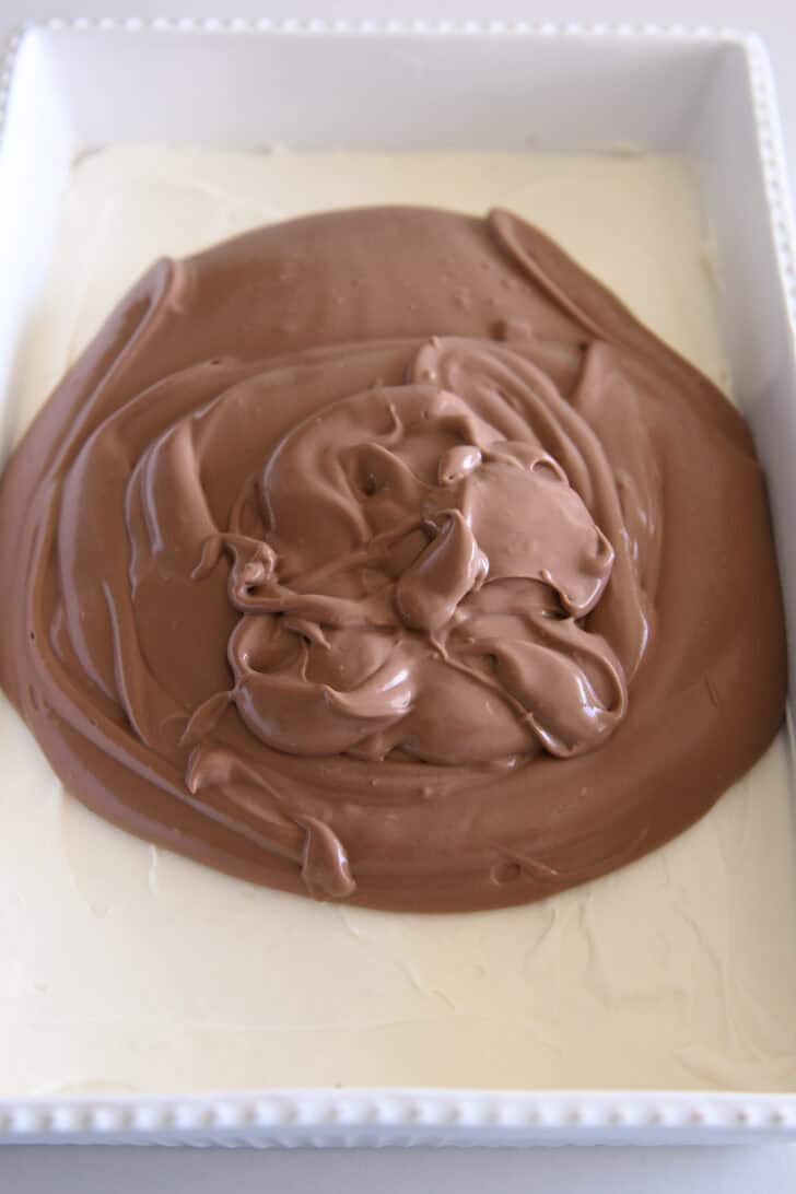 Chocolate pudding on top of cheesecake batter in white 9X13-inch pan.