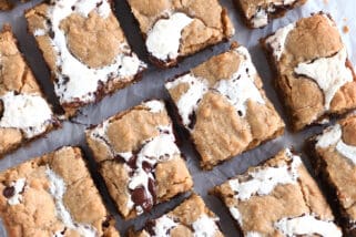 Top down view of golden brown s'mores cookie bars with fissures of gooey marshmallow and melted chocolate throughout each bar.