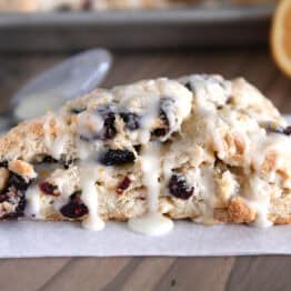Single cranberry orange scone on parchment.