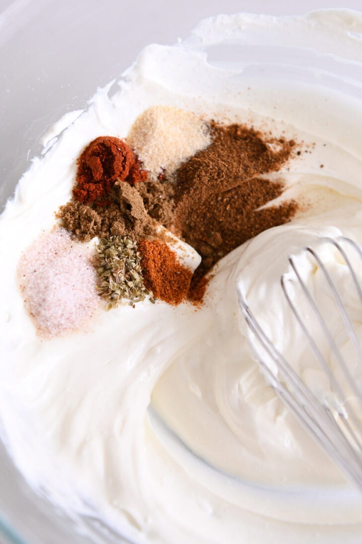 Sour cream and cream cheese mixed together with cumin, chili powder, garlic powder, onion powder, oregano and salt.