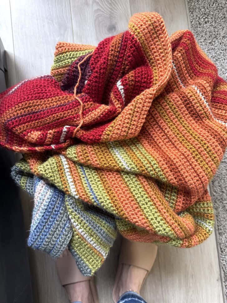 Temperature blanket piled up in basket.