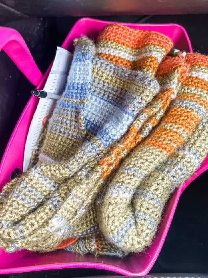 Temperature blanket stuffed into pink bag.