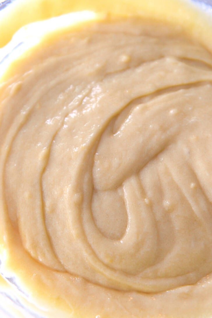 Top down view of a glass bowl with a lemon batter.