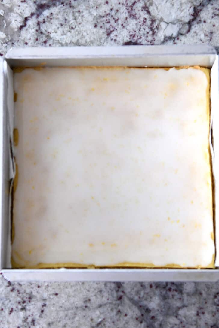 Top down view of a metal pan with cooked and glazed lemon brownie batter.