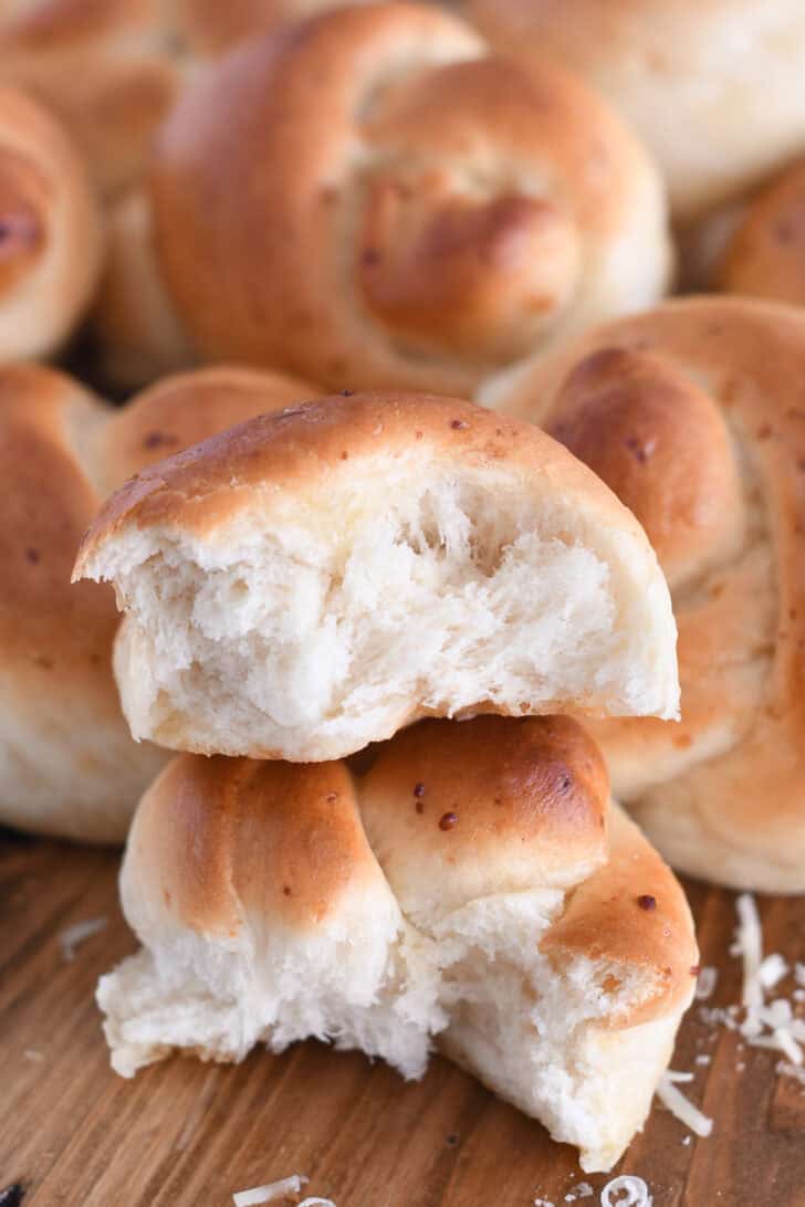 Breadstick knot torn in part and stacked with two halves on top of each other.