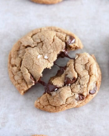 Top down view of chocolate chip cookie pulled in half with melty chocolate chips.