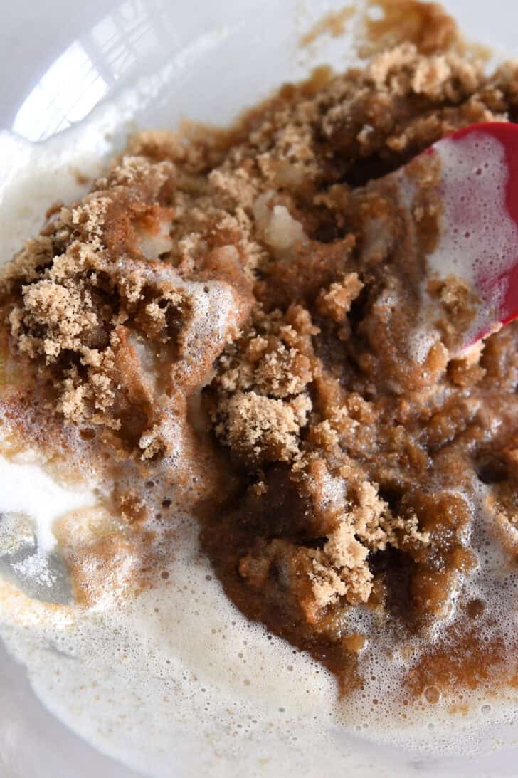Melted brown butter in glass bowl with brown sugar.