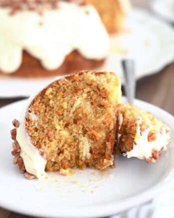 Piece of carrot cake bundt cake on white plate.