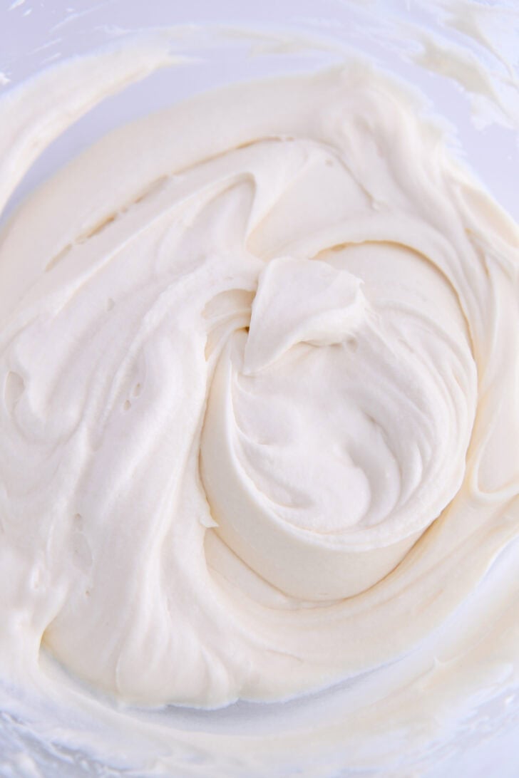 Glass bowl with whipped cream cheese frosting.