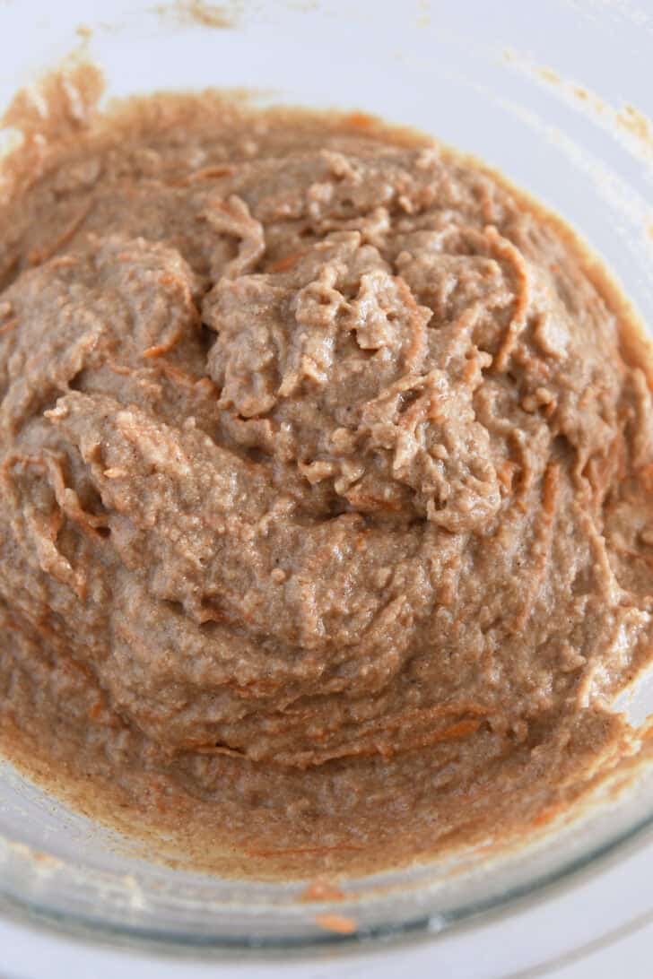 Carrot cake muffin batter in glass bowl.