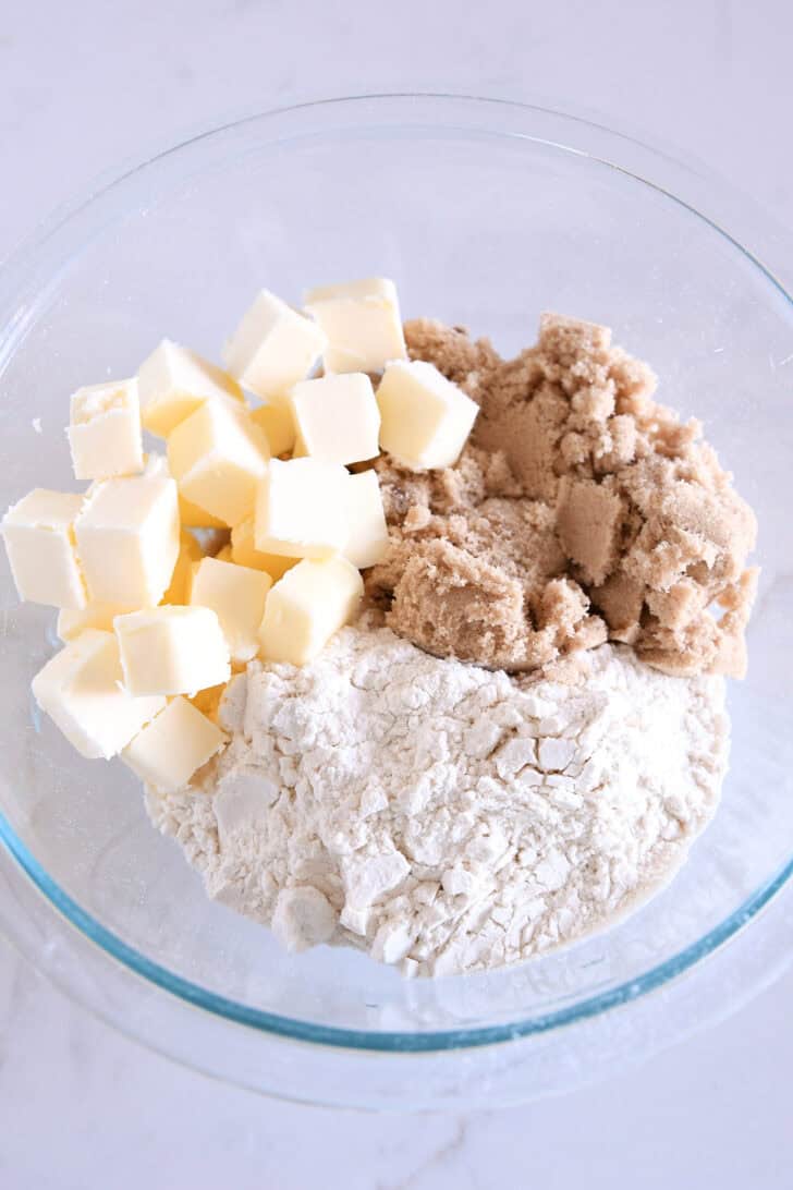 Glass bowl with brown sugar, flour and butter.