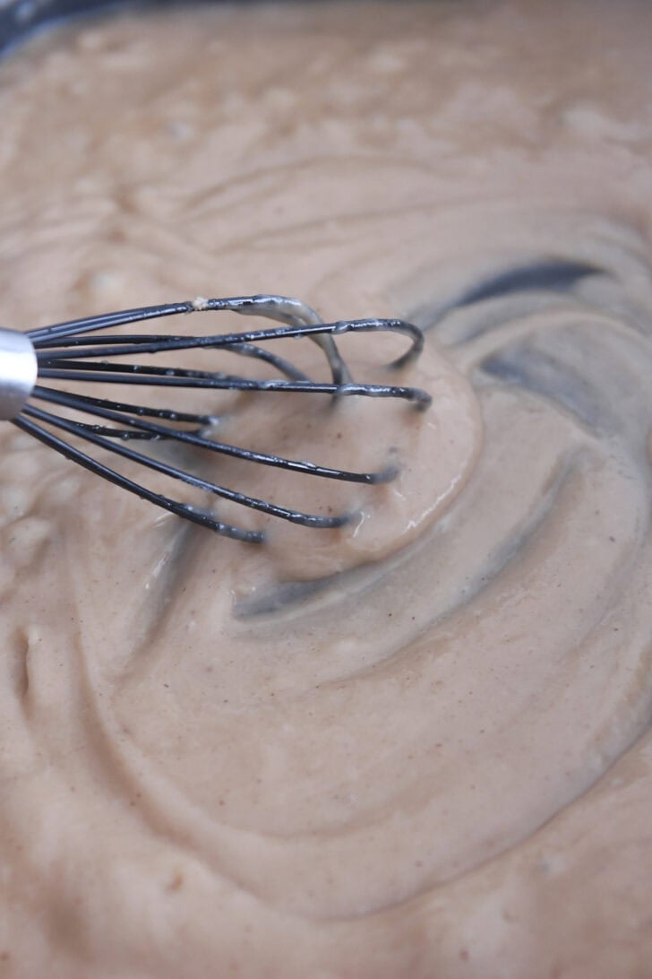 Thick brown gravy whisked in electric skillet.