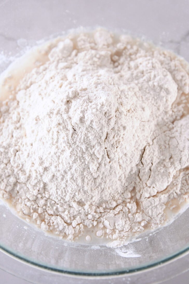 Glass bowl with yeast, water and flour.