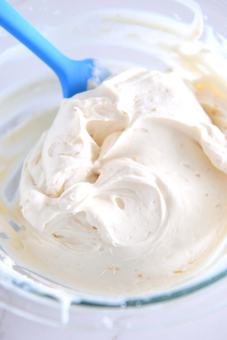 Light and fluffy cream cheese filling in glass bowl.