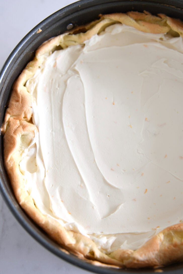Top down view of cream puff shell baked in springform pan filled with cream cheese filling.