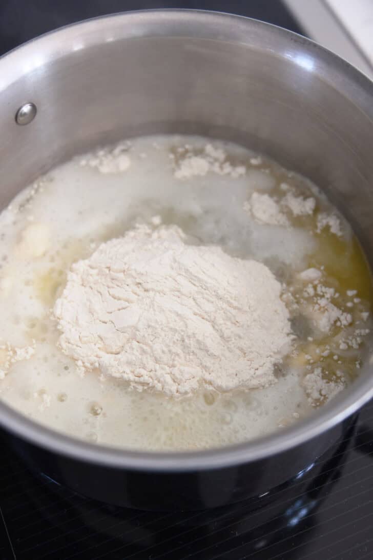 Flour added to water and butter in saucepan.