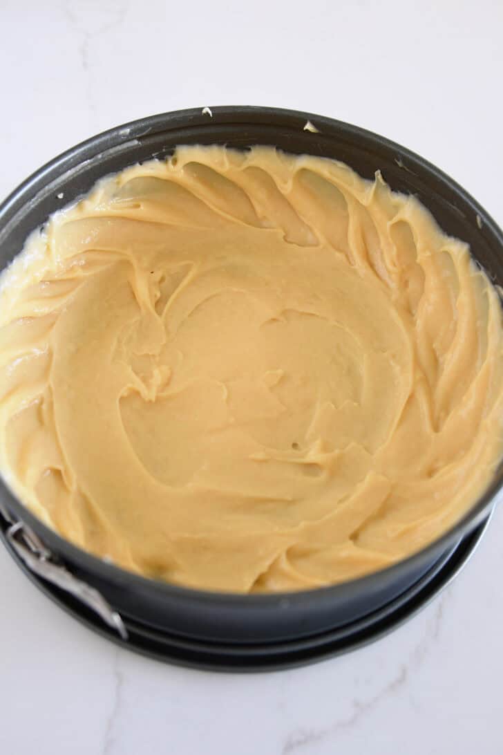 Cream puff dough spread in bottom and up sides of springform pan.
