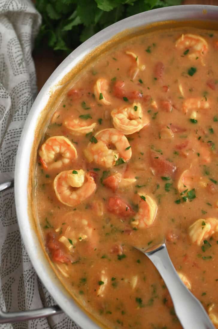 Top down view of a metal pot full of a shrimp curry.