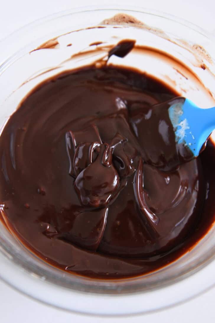 Top down view of glass bowl filled with chocolate ganache.