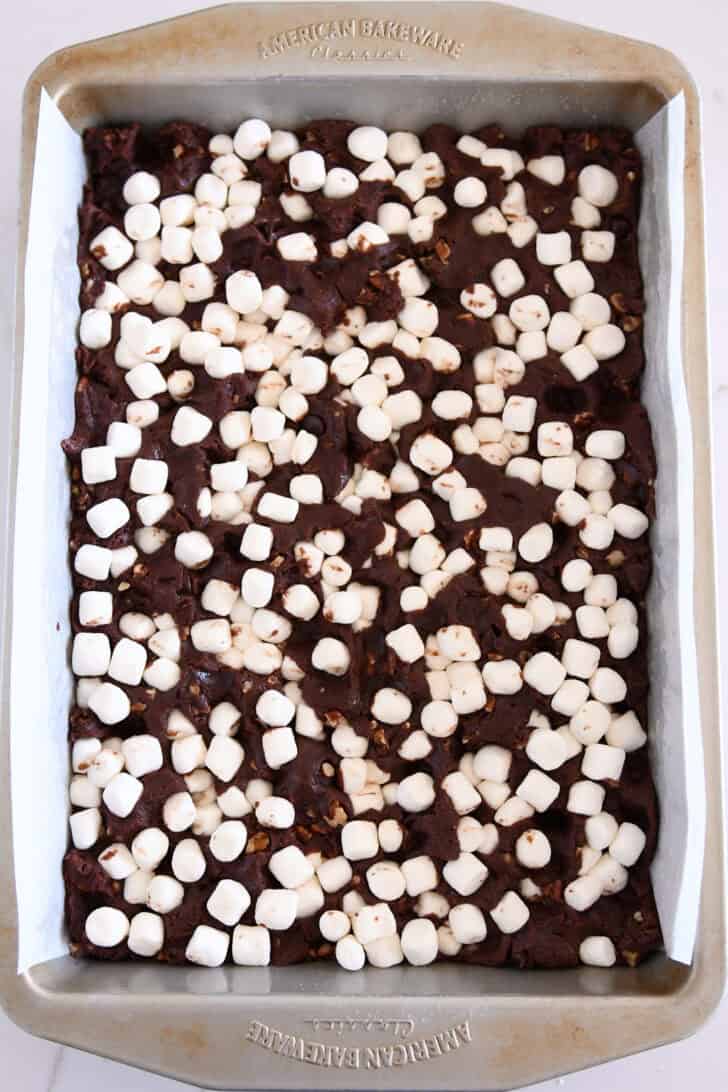 Marshmallows pushed into chocolate chip batter in 9X13-inch pan.